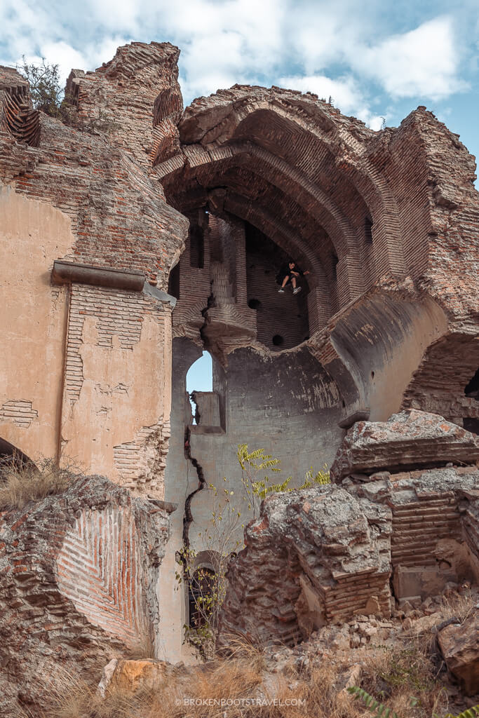 A man jumps between the ruins of an abandoned building
