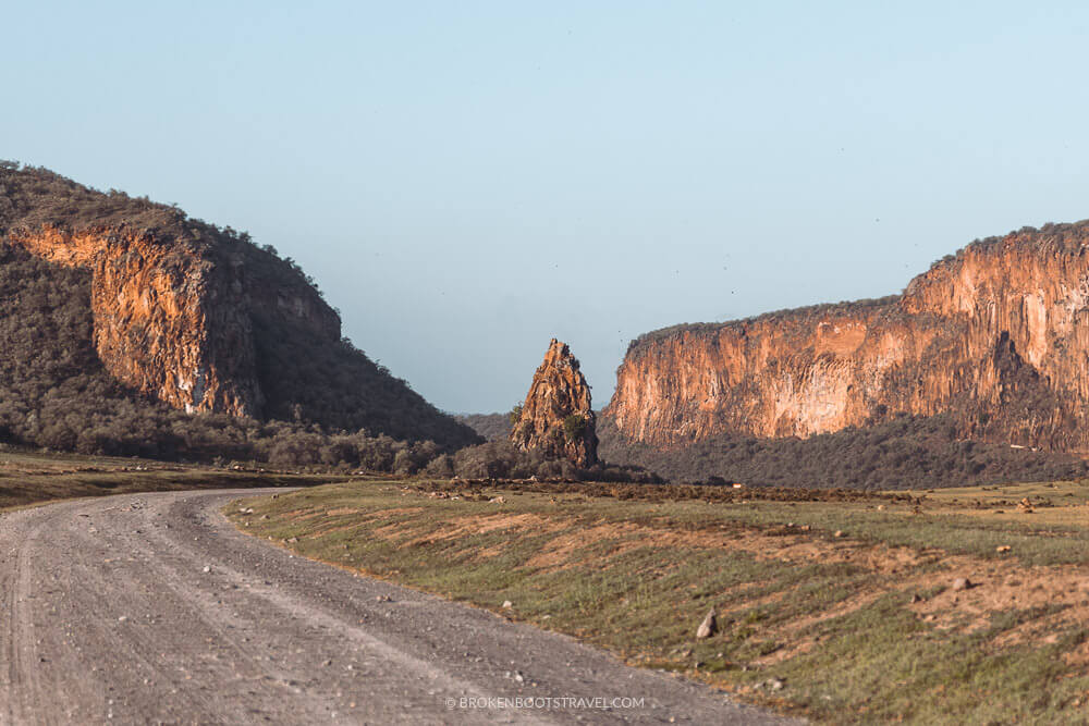 Large rock structures surrounded by cliffs with blue sky