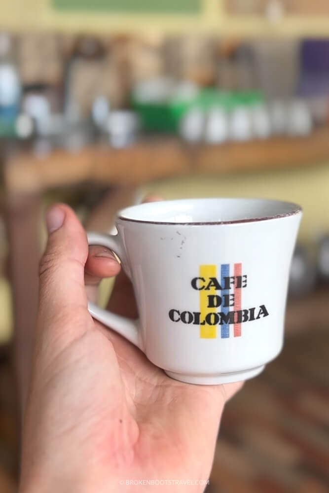 Hang holding a cup that says "Cafe de Colombia"