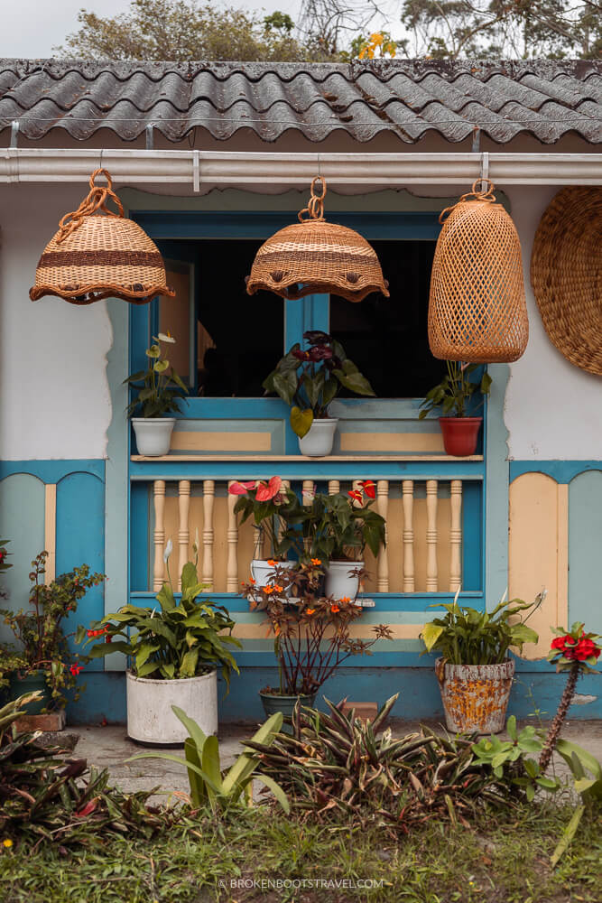 Outside of a colorful house with hanging plants