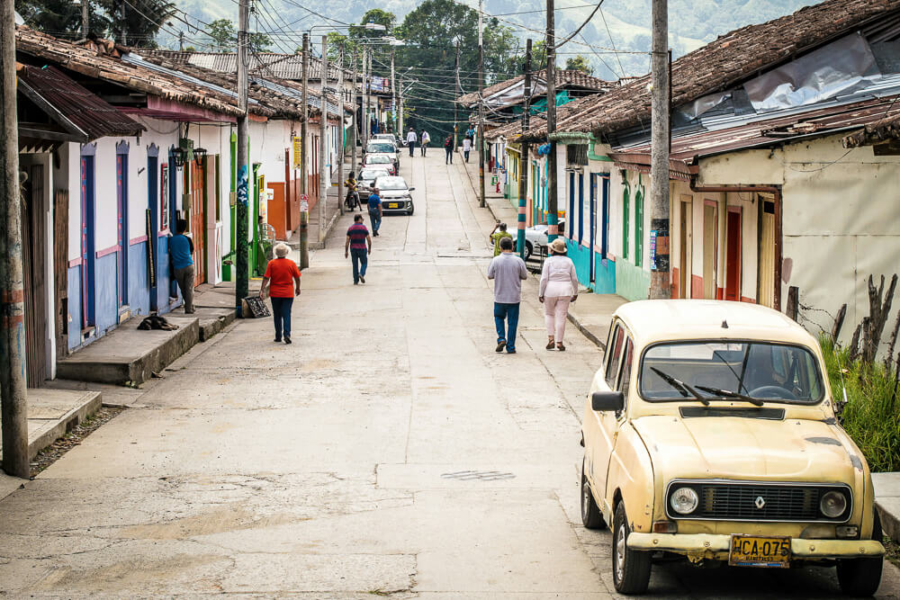 Street of downtown Salento with a yellow car in the foreground