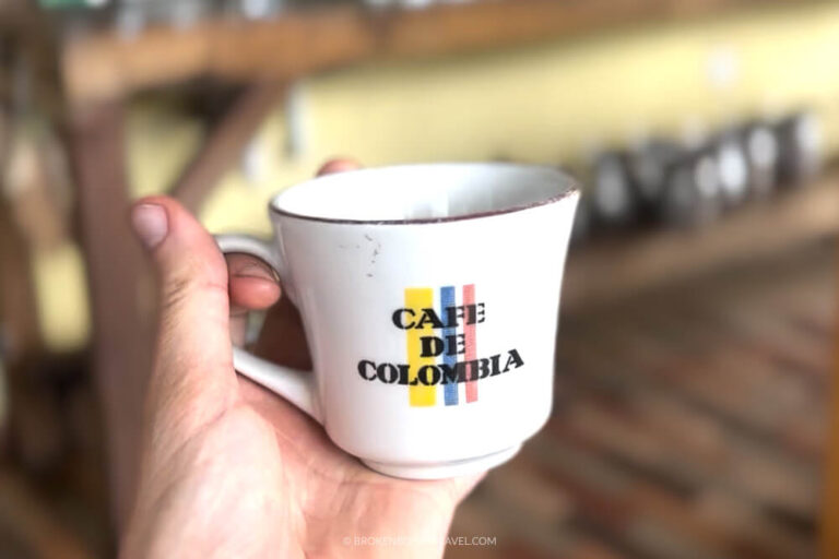 Hand holding Cafe de Colombia cup