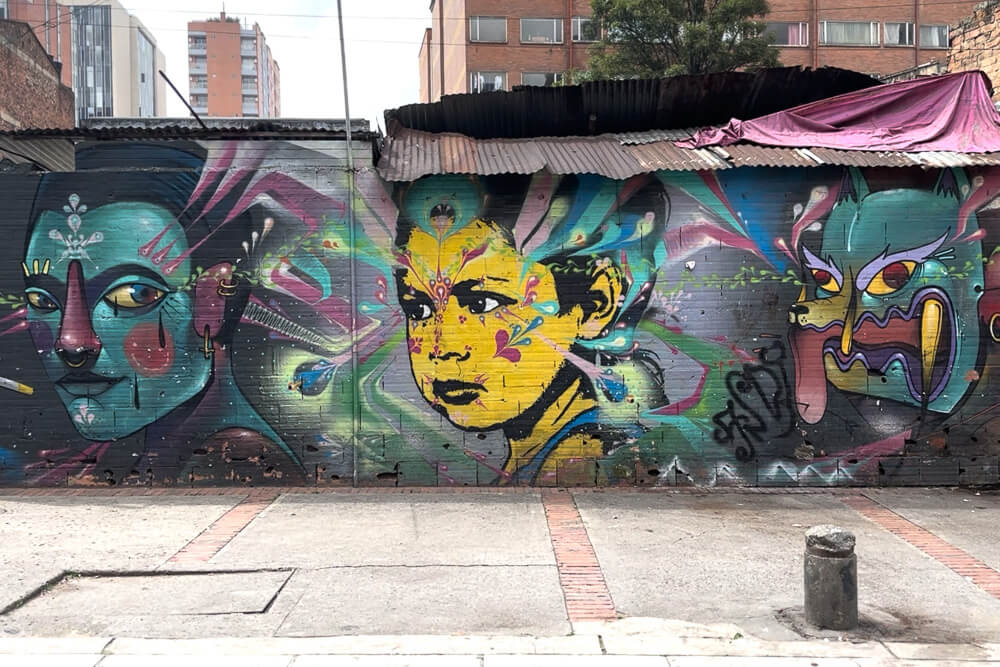 3 faces painted on a wall in Bogota, Colombia