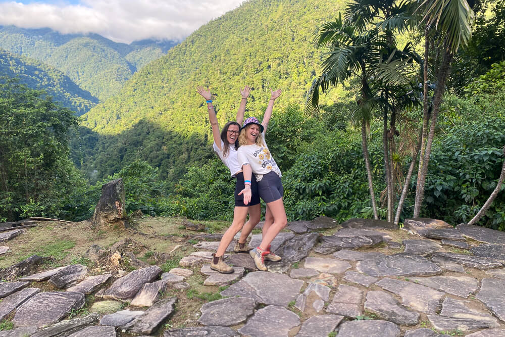 Two girls posing in front of green mountains and palm trees Colombia