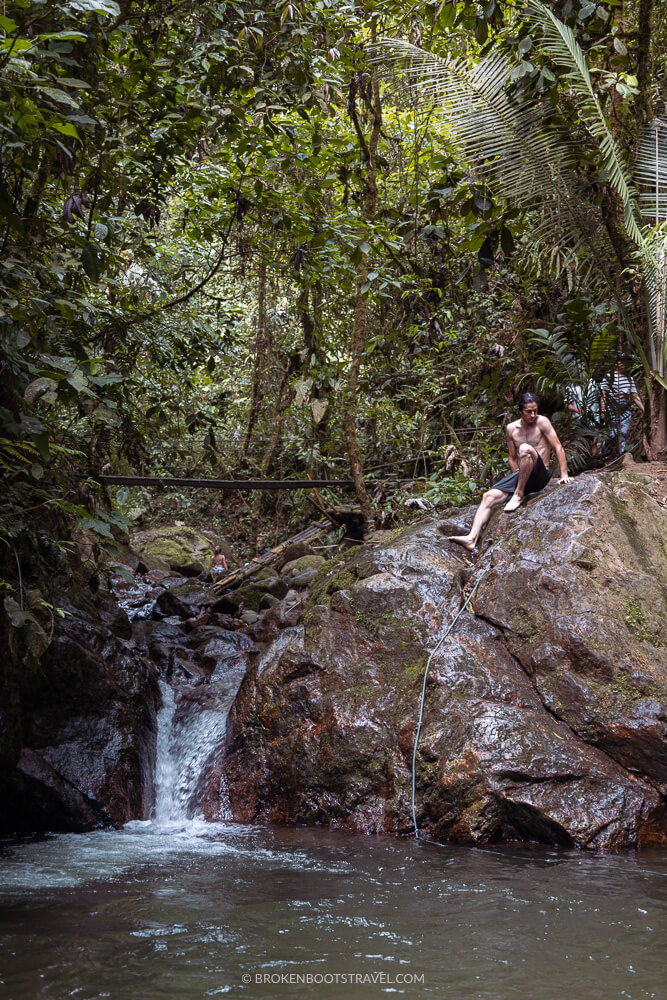 Man sitting on top of waterfall