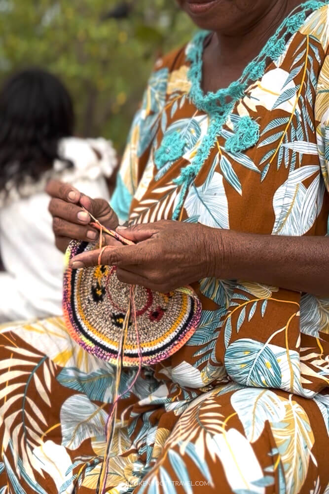 Woman crocheting with multicolored string