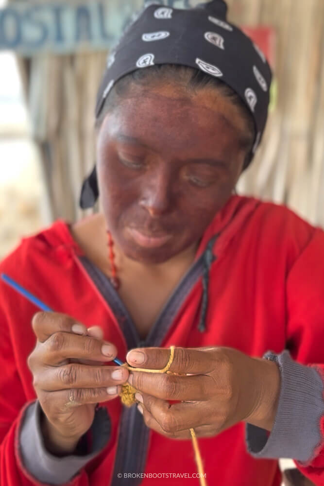 Woman crocheting with yellow string