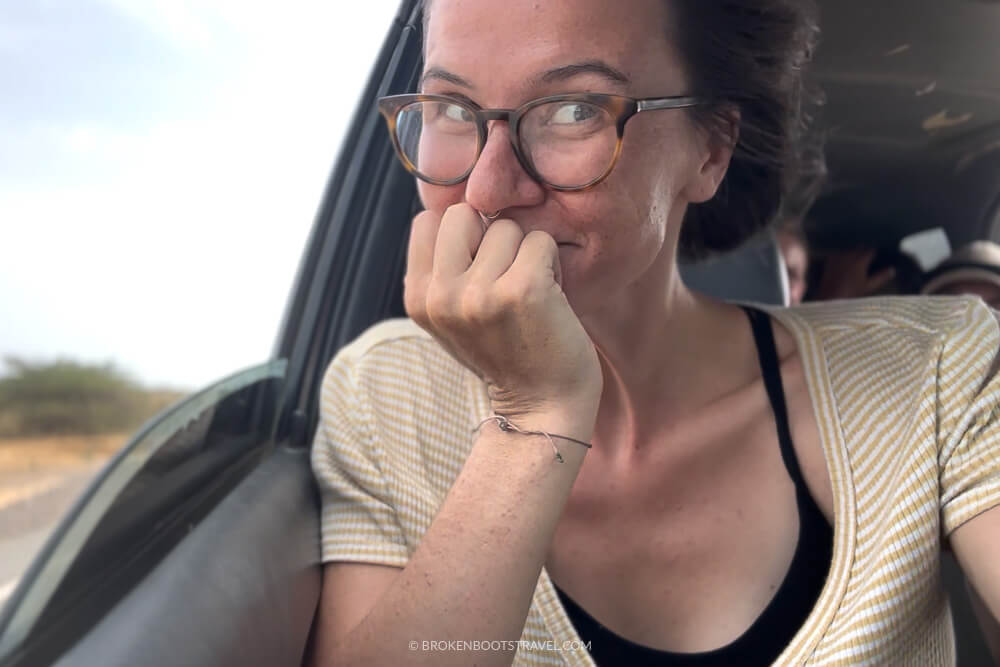 Girl in yellow shirt smiling by open car window