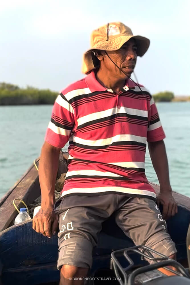 Man in red striped shirt in a boat La Guajira