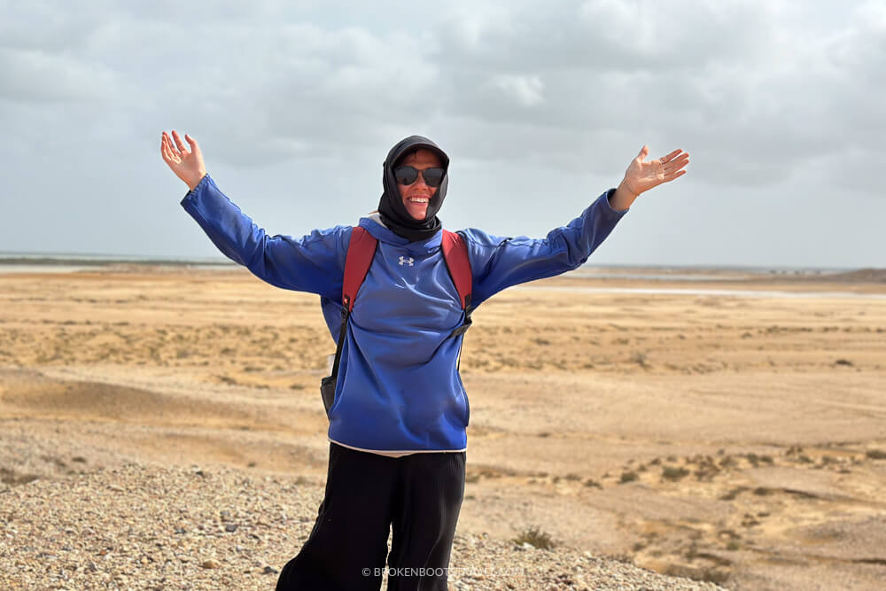 Girl in blue sweatshirt in desert landscape