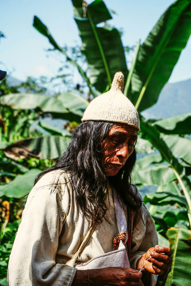 Kogi man making a bracelet