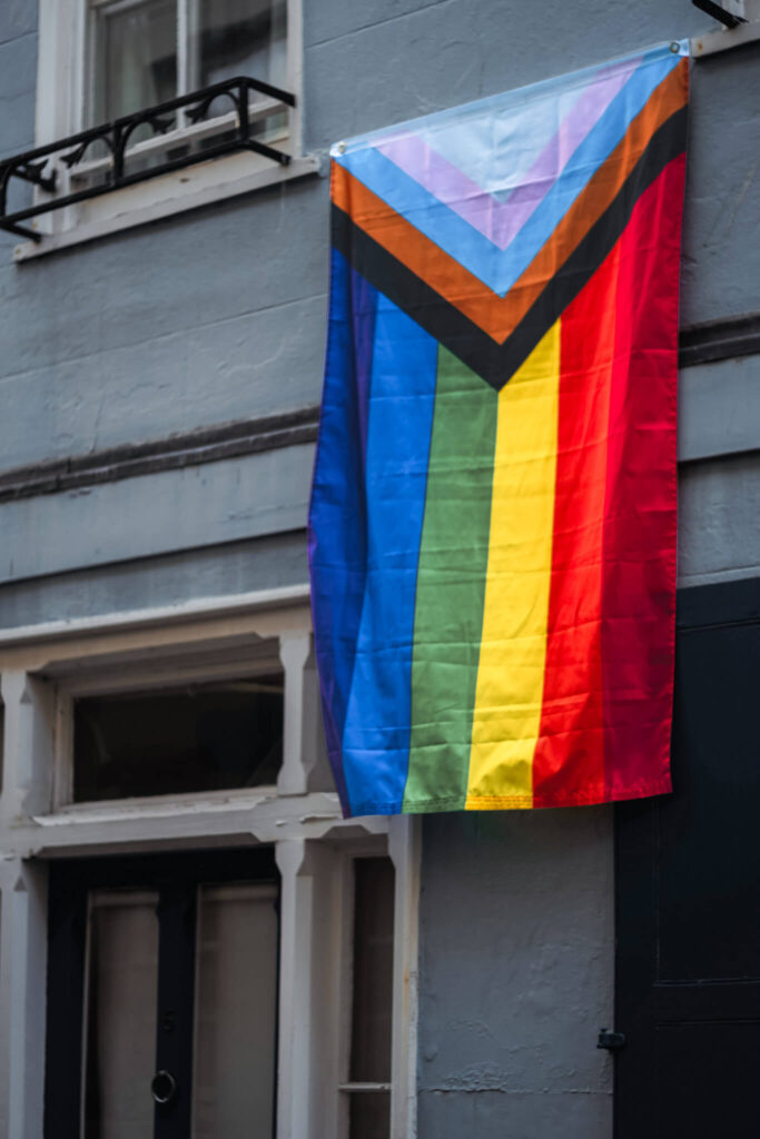 Pride flag hanging from a window