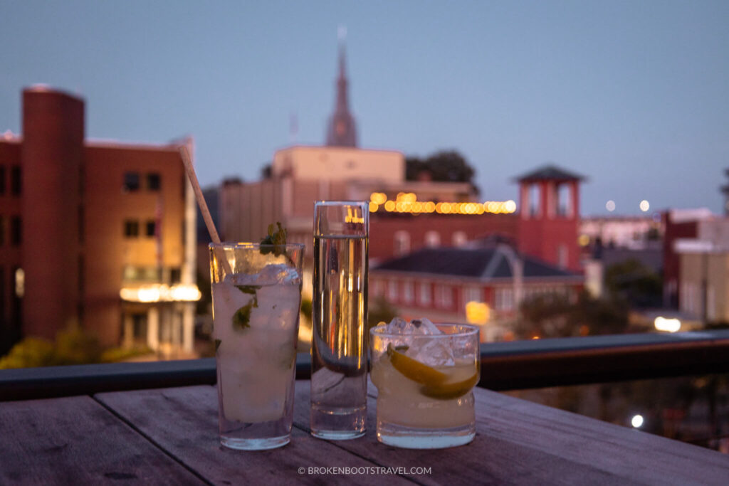 3 cocktails in front of the Durham city skyline