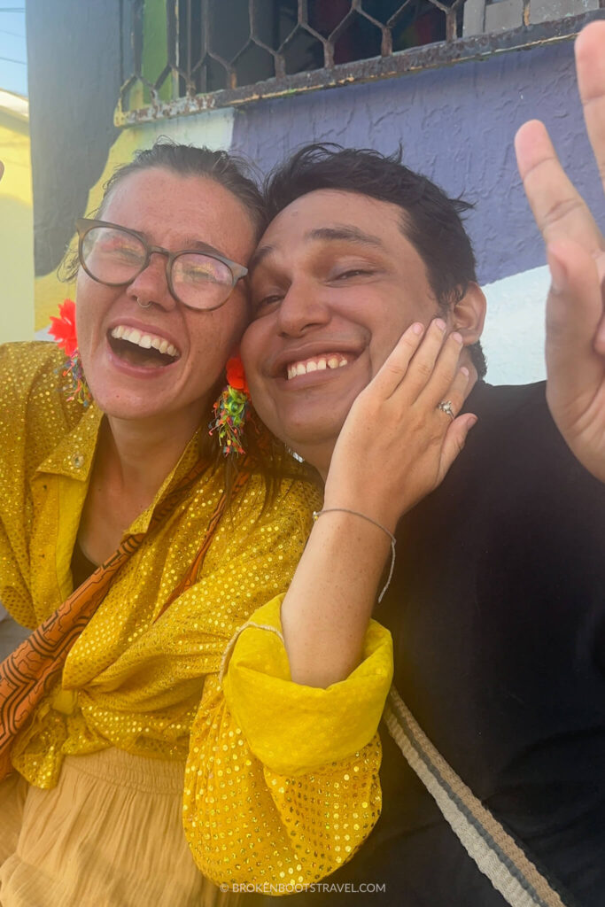 Girl in yellow shirt hugging guy in black shirt