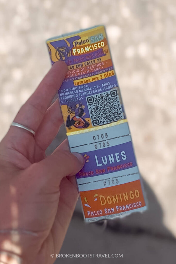 Hand holding a ticket to Barranquilla Carnival