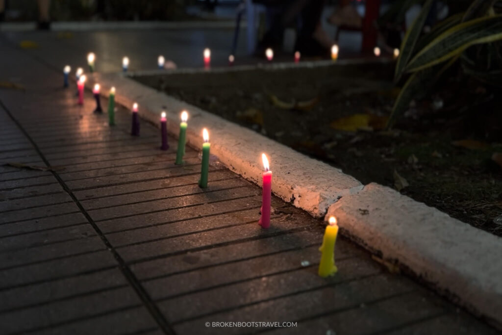 Candles along the sidewalk for Noche de Velitas Celebration