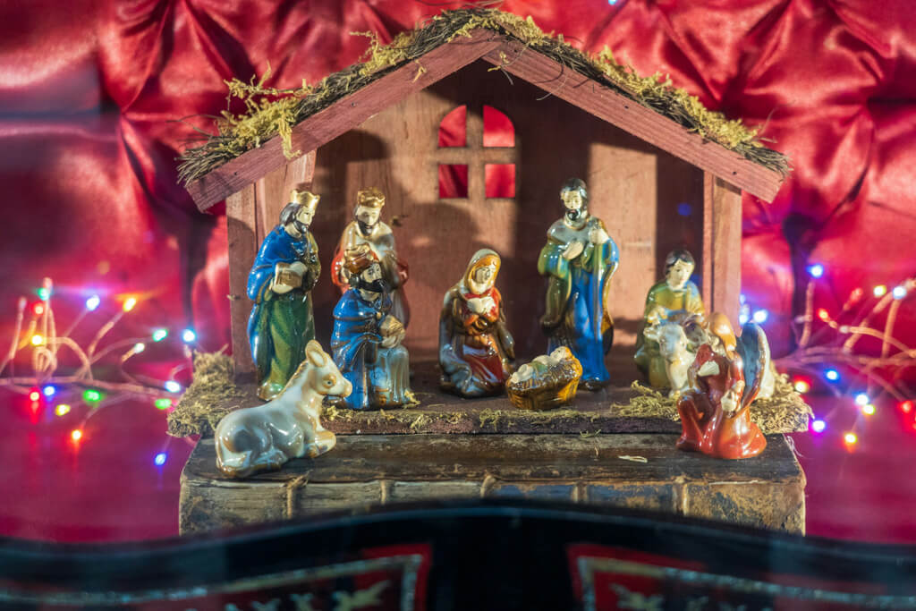 nativity scene in front of a red background