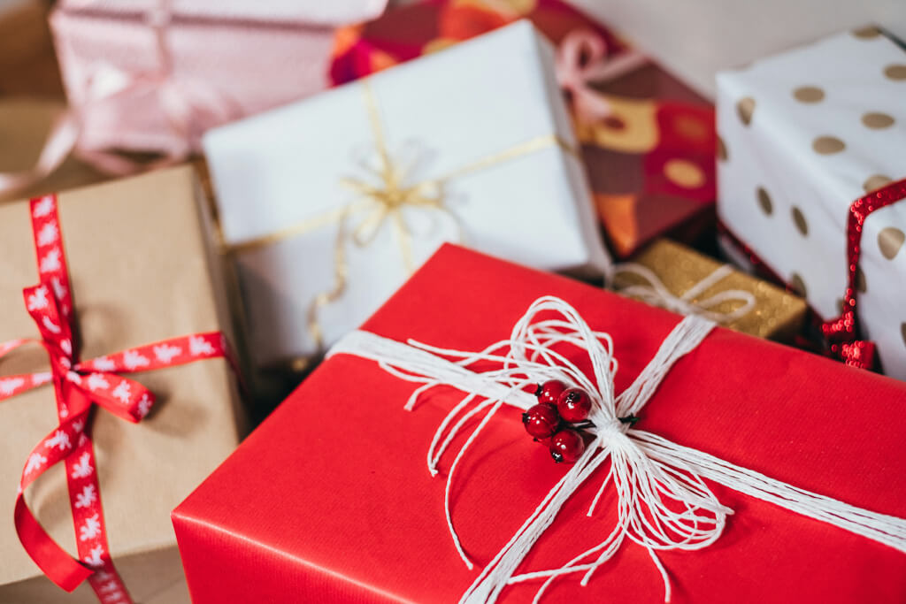 pile of presents in different christmas colors