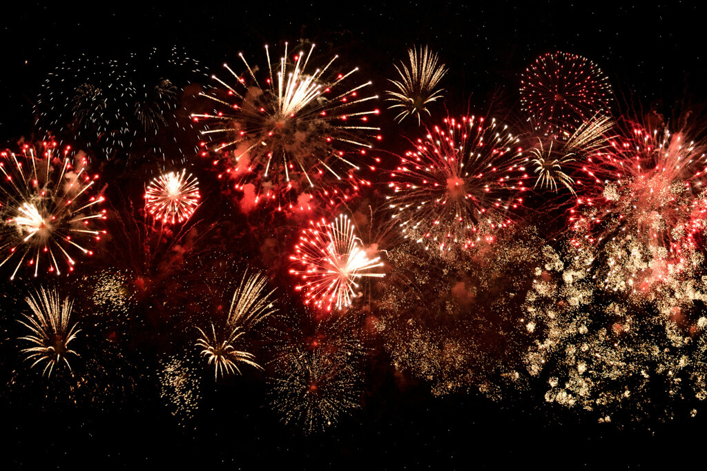 red and yellow fireworks against a black background