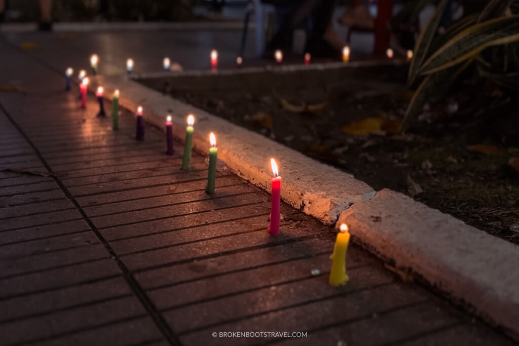 small candles on the sidewalk for noche de velitas in colombia