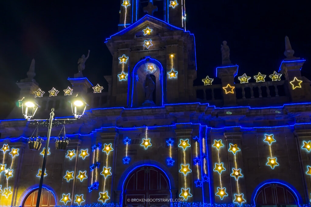 a church decorated with blue and yellow christmas lights in colombia