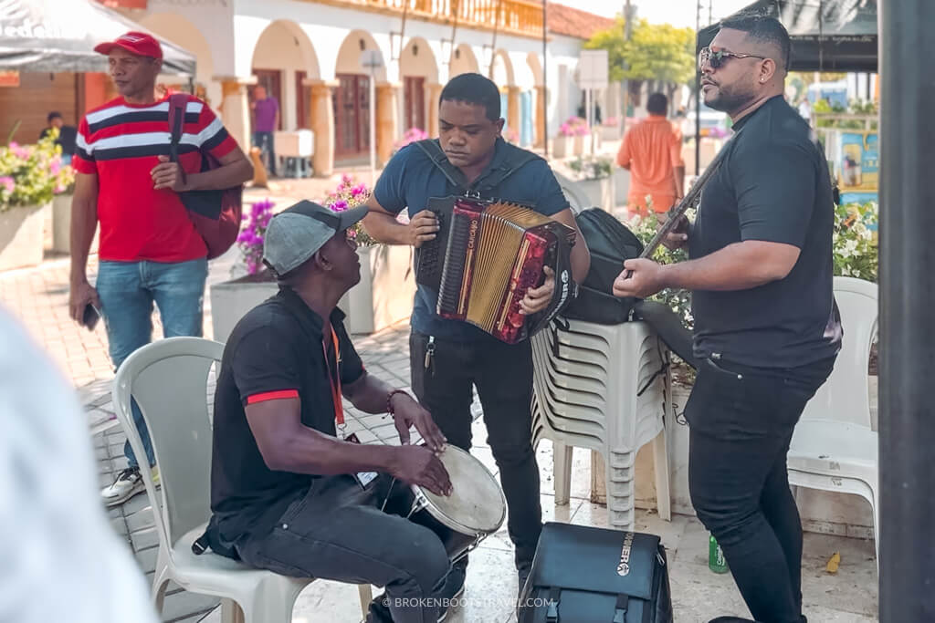 Three men playing Vallenato music in the street