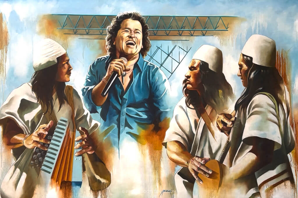 Mural of Carlos Vives singing with three indigenous men