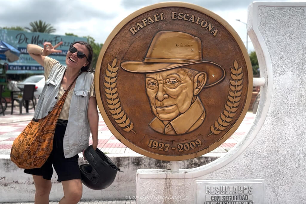 Girl posing with statue of Rafael Escalona