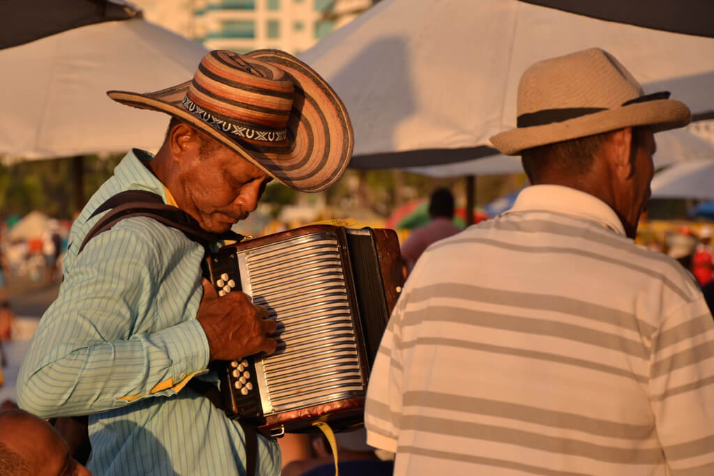 Man in sombrro vueltiao playing accordion