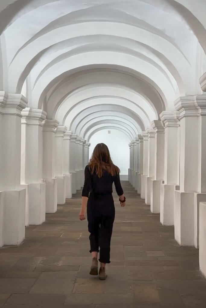 Girl in black walking through the National Gallery in Bogota, Colombia