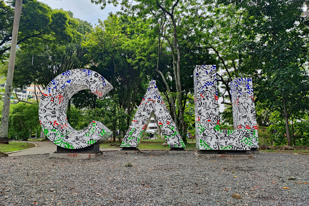 large white letters spelling "cali" in front of green trees