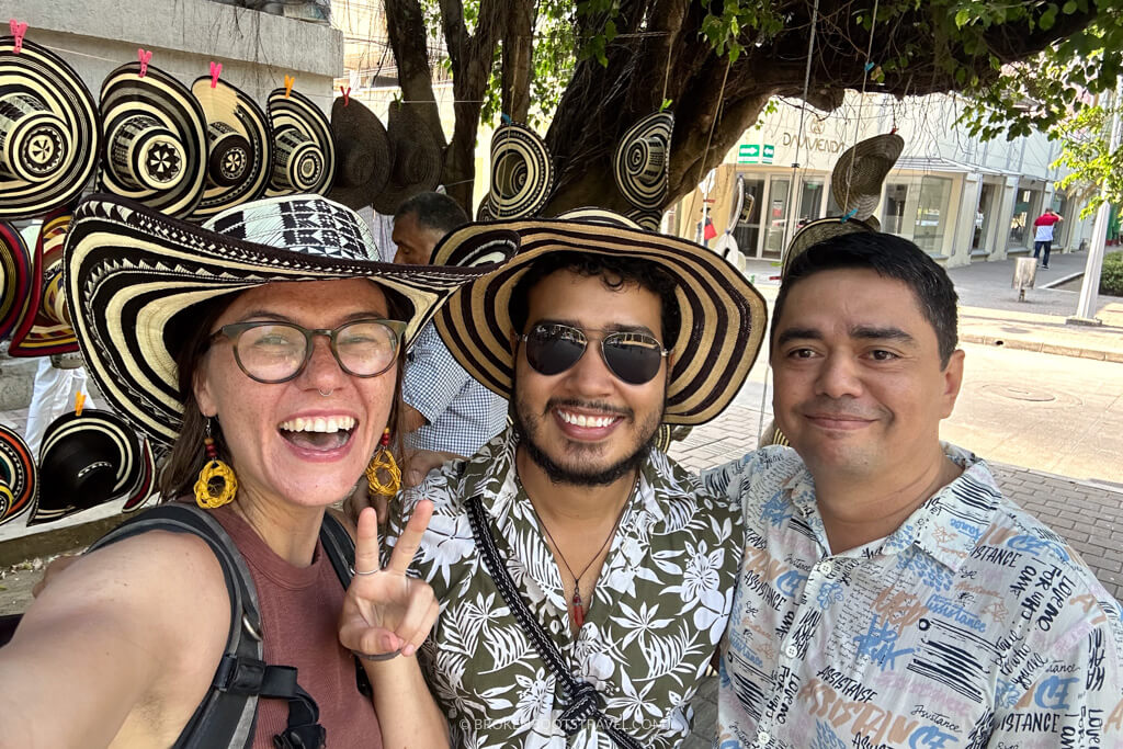 three smiling people wearing black and white sombrero vueltiaos in Colombia