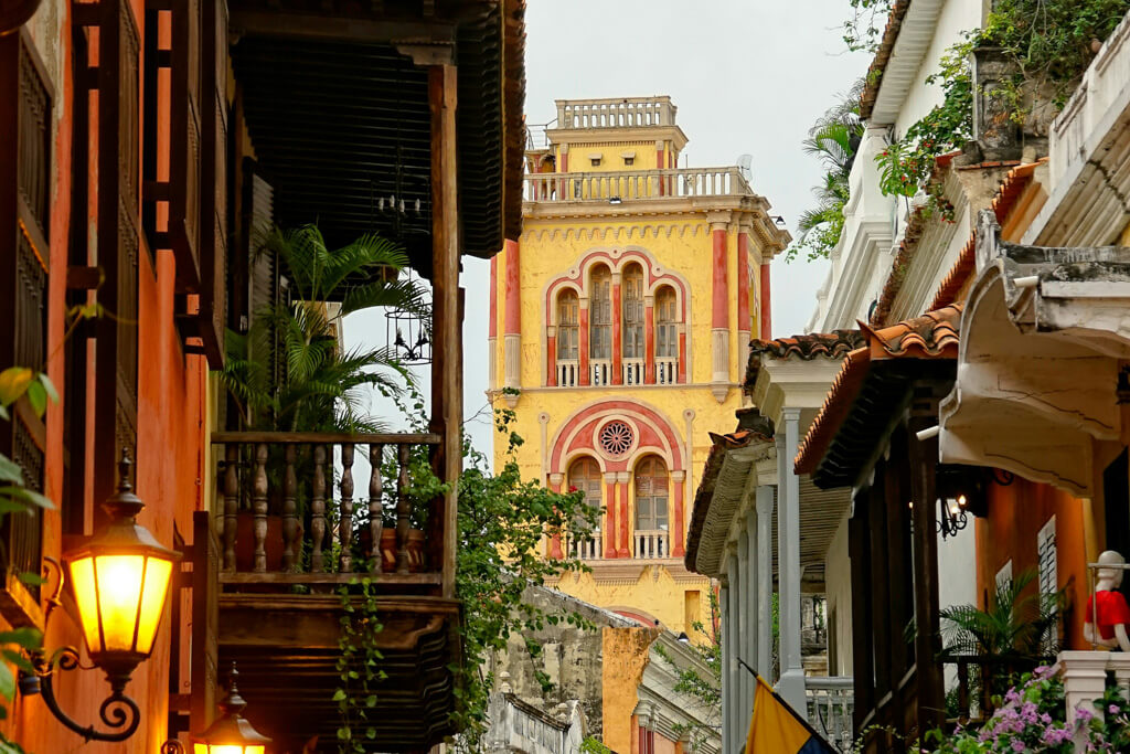 Yellow colonial church surrounded by other colorful buildings in Cartagena, Colombia