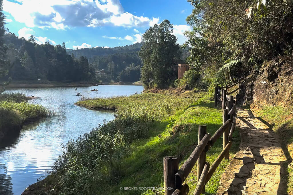 Parque Arvi, Medellin, lake with boats in it and a path through lush green foliage