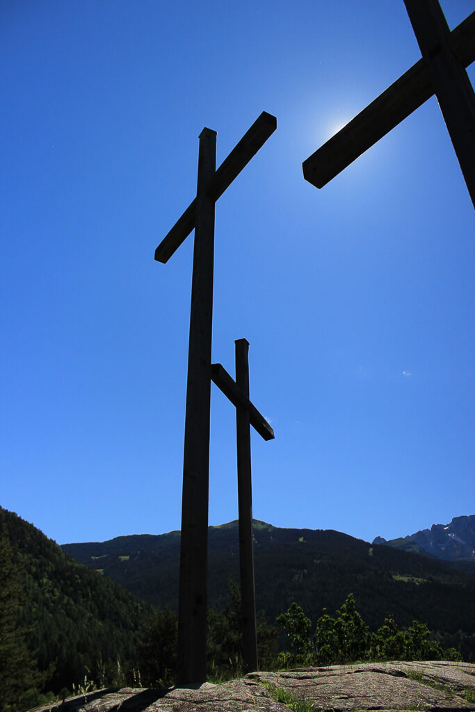 Three crosses with a blue sky in the background