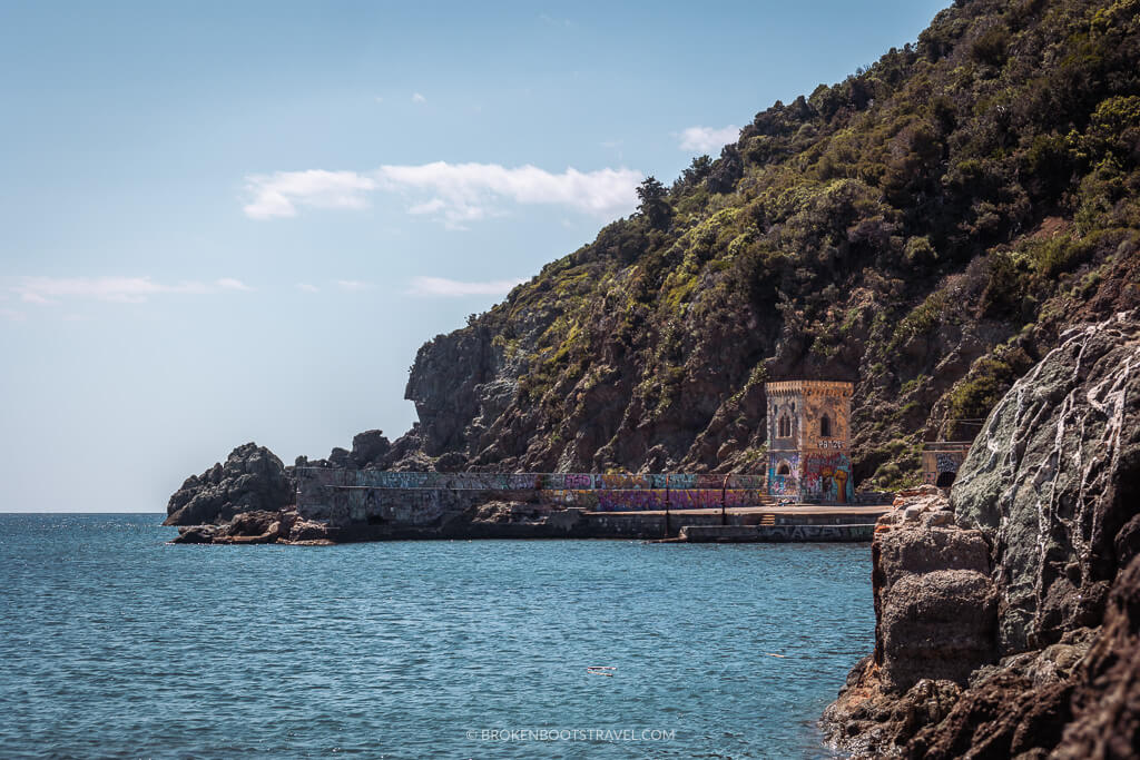 Abandoned castle below rocky cliff on the seaside