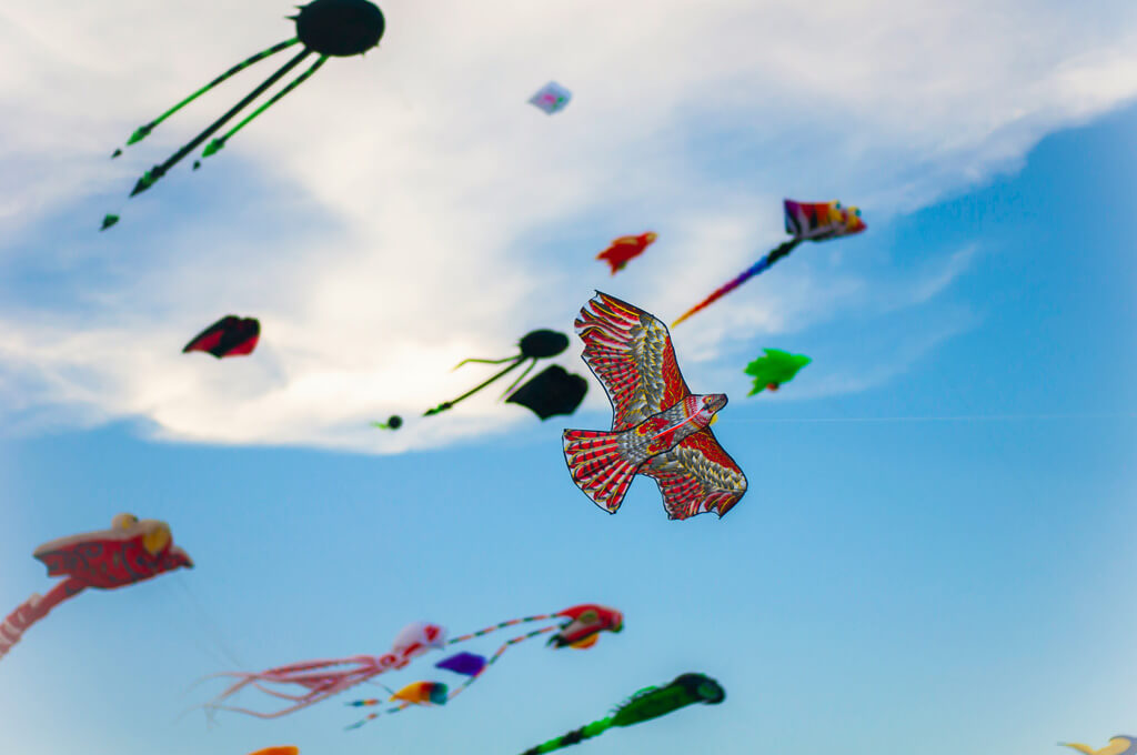 Colorful kites against blue sky