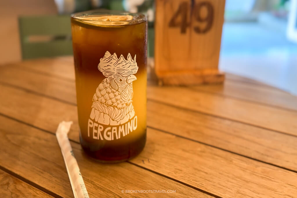 Coffee in a glass cup with a chicken on the front