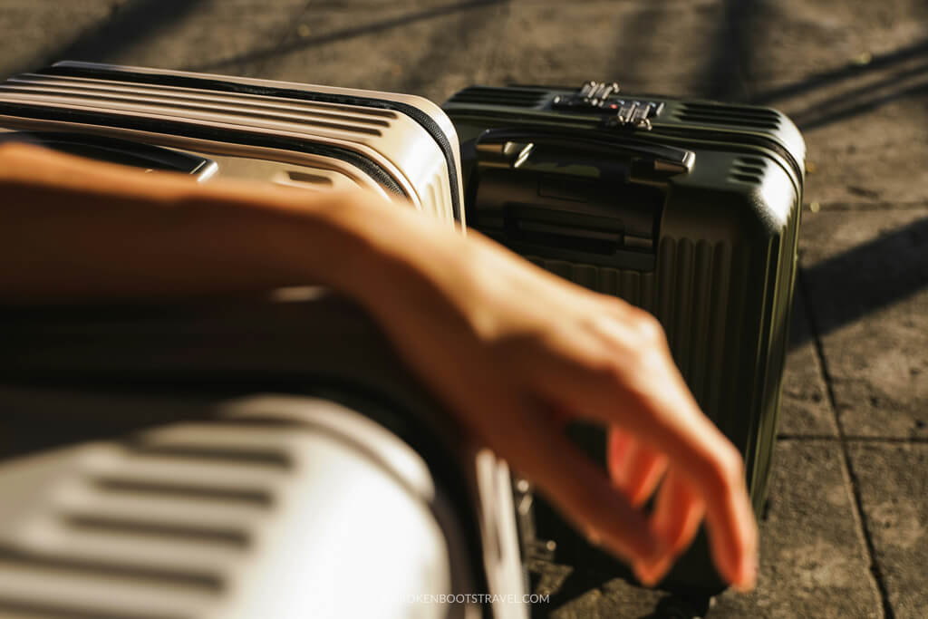 Hand resting on a silver suitcase