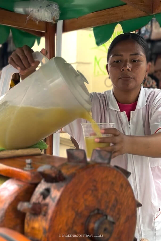 Woman pouring a cup of jugo de caña