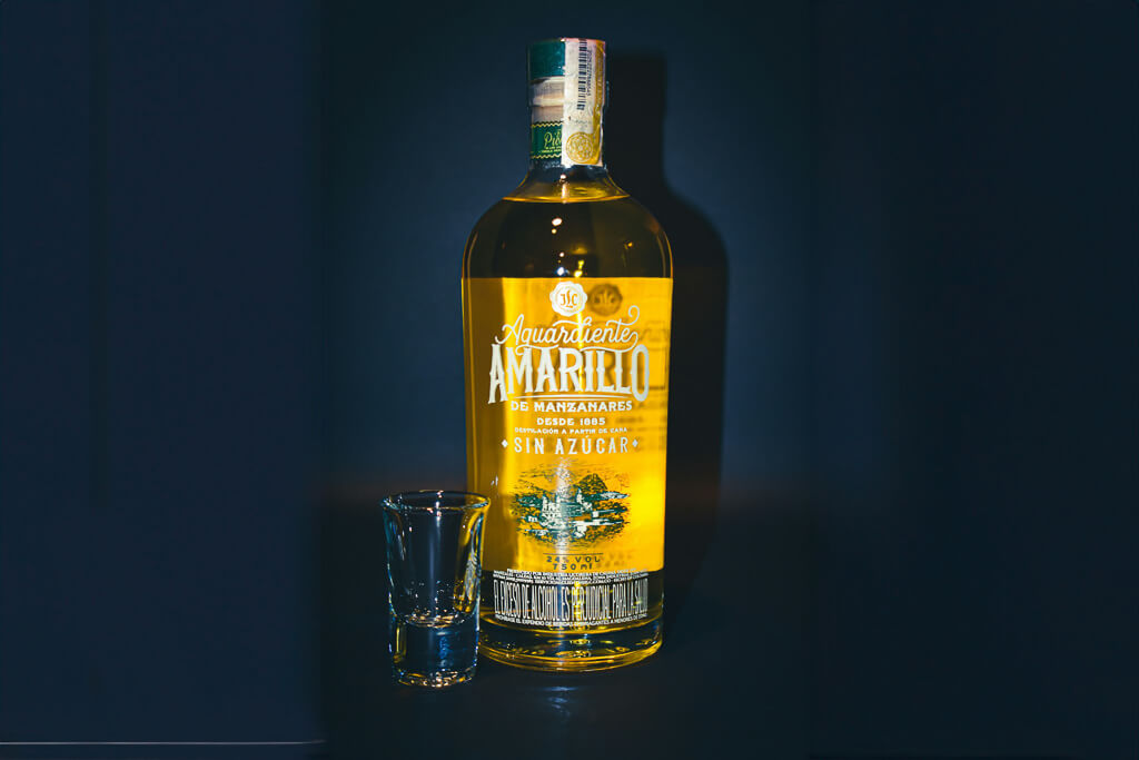 Aguardiente Amarillo in front of a black background