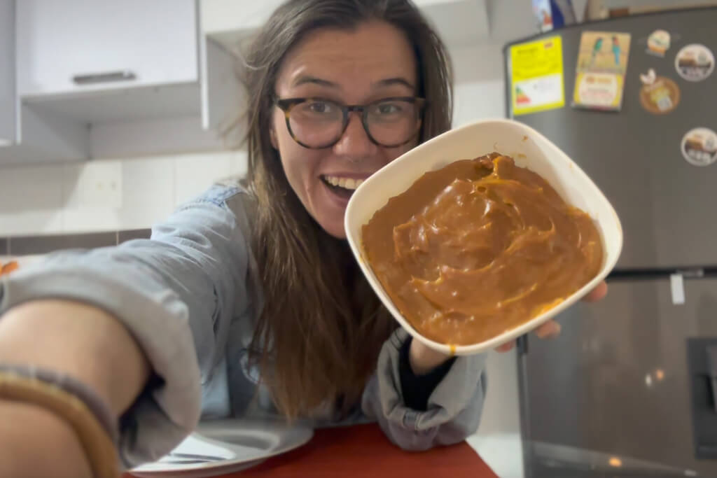 Girl in blue shirt holding a bowl of natilla