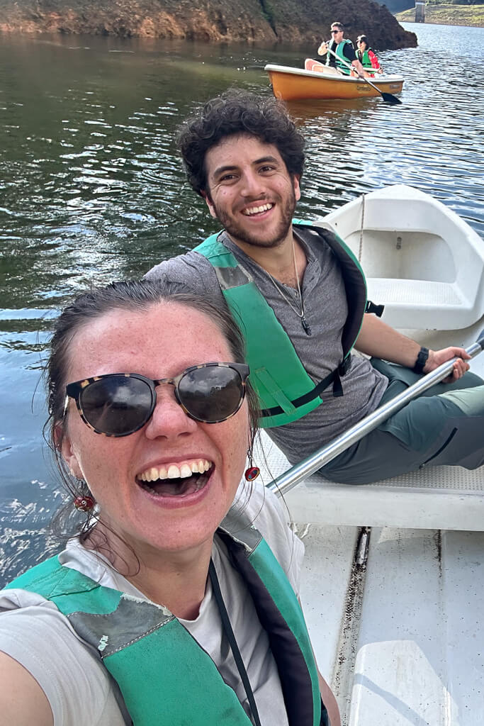 Man and woman smiling in a boat on a lake