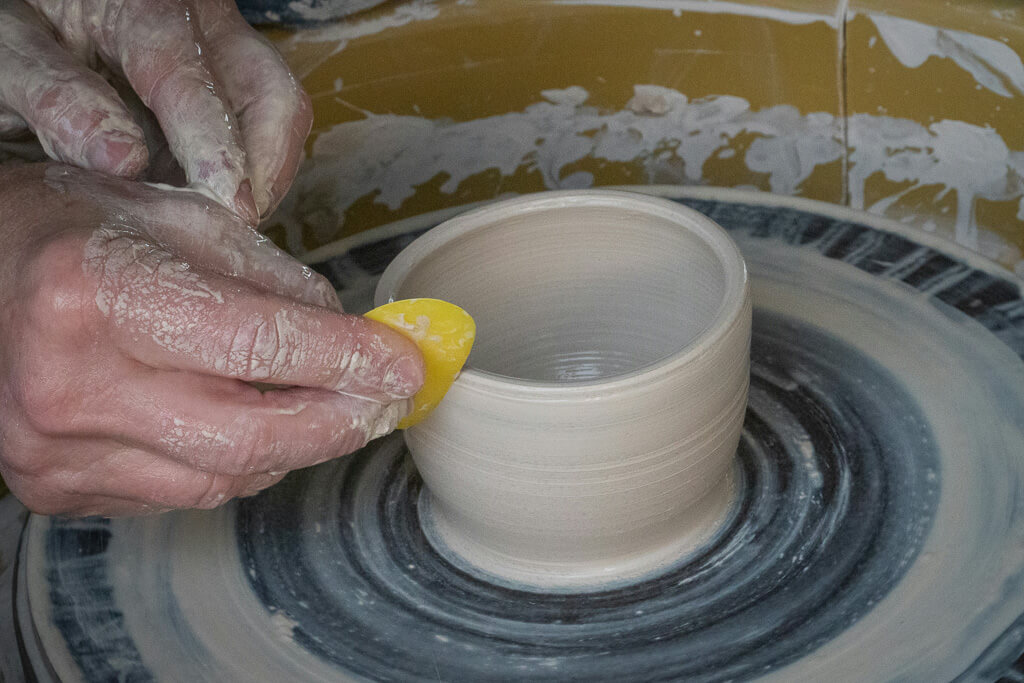 Hands making a piece of pottery in El Carmen de Viboral, Antioquia
