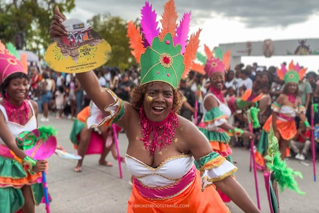 A woman wearing a traditional costume and dancing at the San Pacho Festival