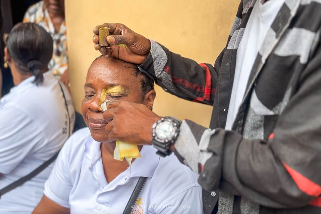 A woman getting her face painted for the San Pacho Festival