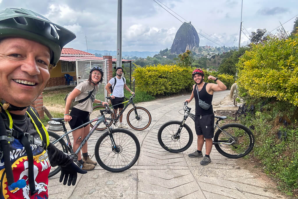 Four people smiling for a selfie with bikes in the Colombian countryside
